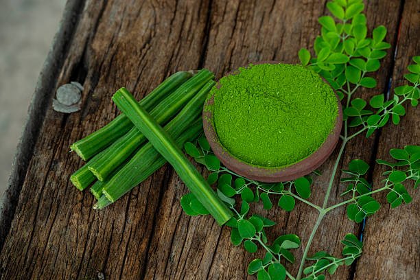 Moringa oleifera powder, Drumstick leaf powder on wooden background